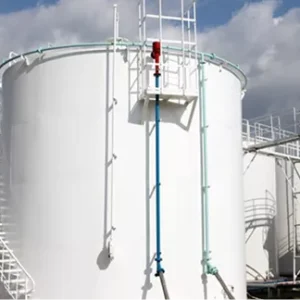 Industrial refinery tanks surrounded by a thick, chemical-resistant polyurea secondary containment lining.